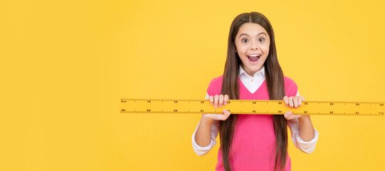 surprised kid girl use ruler to learn mathematics, measurement. Banner of school girl student. Schoolgirl pupil portrait with copy space.