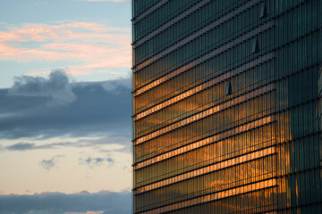 Wall Mural - Sunset sky reflection in the windows of a new modern office corporation building. Modern architecture in Belgium.