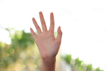 Beautiful young hand , little girl hand up, Woman hand showing the five fingers