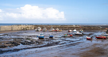 Fishing Boats On The Beach At Low Tide In Staithes Harbour