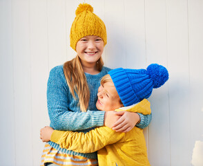 Wall Mural - Outdoor portrait of 2 funny kids wearing yellow and blue clothes, fashion for young children