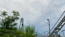 Amusement Park Against A Cloudy Sky View, People Ride Rollercoaster Closeup Concept, Recreation In The Amusement Park, Roller Coaster Fun Time, Leisure , Going Down Hills 