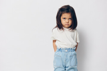 Wall Mural - offended little girl stands near the wall