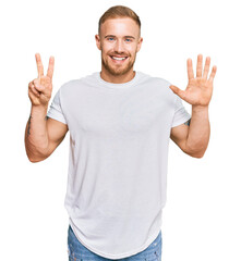 Wall Mural - Young irish man wearing casual clothes showing and pointing up with fingers number seven while smiling confident and happy.