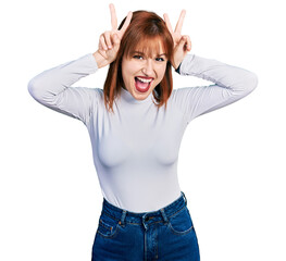 Poster - Redhead young woman wearing casual turtleneck sweater posing funny and crazy with fingers on head as bunny ears, smiling cheerful