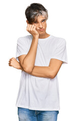 Sticker - Young hispanic man wearing casual white tshirt thinking looking tired and bored with depression problems with crossed arms.