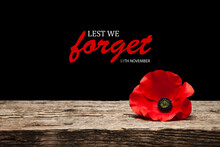 Poppy Pin For Remembrance Day. Poppy Flower On Old Beautiful High Grain, Detailed Wood On Black Background With Text.