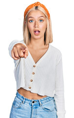 Canvas Print - Beautiful young blonde woman wearing casual white sweater pointing displeased and frustrated to the camera, angry and furious with you