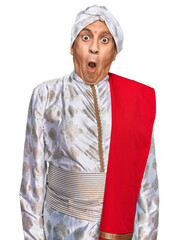 Canvas Print - Senior hispanic man wearing tradition sherwani saree clothes afraid and shocked with surprise expression, fear and excited face.