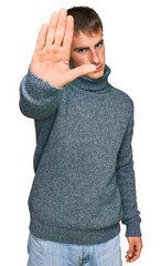 Poster - Young blond man wearing casual clothes doing stop sing with palm of the hand. warning expression with negative and serious gesture on the face.