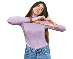 Poster - Young beautiful teen girl wearing turtleneck sweater smiling in love doing heart symbol shape with hands. romantic concept.