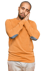 Wall Mural - Hispanic adult man wearing casual winter sweater sleeping tired dreaming and posing with hands together while smiling with closed eyes.