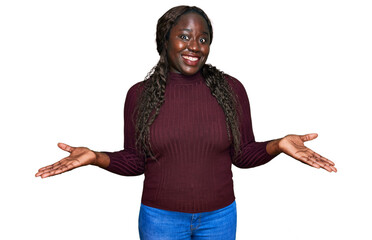 Poster - Young african woman wearing casual winter sweater clueless and confused expression with arms and hands raised. doubt concept.