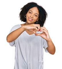 Wall Mural - Young african american girl wearing casual clothes smiling in love doing heart symbol shape with hands. romantic concept.