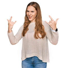 Sticker - Young blonde woman wearing casual clothes shouting with crazy expression doing rock symbol with hands up. music star. heavy concept.