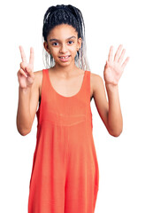 Sticker - Cute african american girl wearing casual clothes showing and pointing up with fingers number seven while smiling confident and happy.