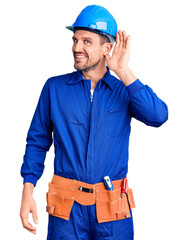 Poster - Young handsome man wearing worker uniform and hardhat smiling with hand over ear listening an hearing to rumor or gossip. deafness concept.