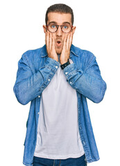 Poster - Young caucasian man wearing casual clothes afraid and shocked, surprise and amazed expression with hands on face