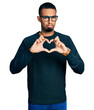 © Krakenimages.com - Young african american man doing heart symbol with hands depressed and worry for distress, crying angry and afraid. sad expression.