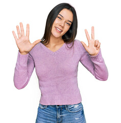 Poster - Young hispanic girl wearing casual clothes showing and pointing up with fingers number eight while smiling confident and happy.