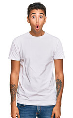 Sticker - Young handsome african american man wearing casual white tshirt afraid and shocked with surprise expression, fear and excited face.