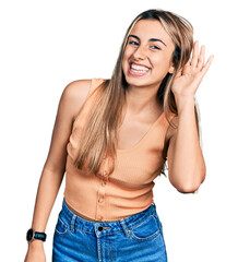 Poster - Hispanic young woman wearing casual summer shirt smiling with hand over ear listening an hearing to rumor or gossip. deafness concept.