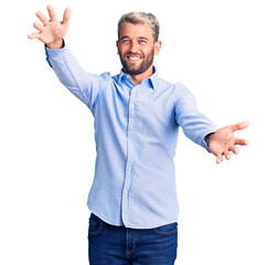 Poster - Young handsome blond man wearing elegant shirt looking at the camera smiling with open arms for hug. cheerful expression embracing happiness.