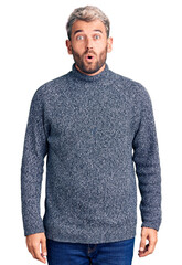 Sticker - Young handsome blond man wearing casual sweater scared and amazed with open mouth for surprise, disbelief face