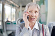 © JackF - European elderly woman sitting inside tram and waiting for next stop.