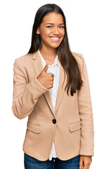 Sticker - Beautiful hispanic woman wearing business jacket doing happy thumbs up gesture with hand. approving expression looking at the camera showing success.