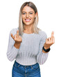 © Krakenimages.com - Beautiful blonde woman wearing casual clothes showing middle finger doing fuck you bad expression, provocation and rude attitude. screaming excited