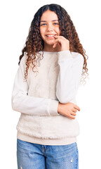 beautiful kid girl with curly hair wearing casual clothes looking confident at the camera with smile