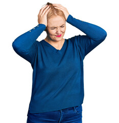 Wall Mural - Young blonde woman wearing casual clothes suffering from headache desperate and stressed because pain and migraine. hands on head.