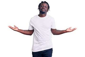 Wall Mural - Young african american man with braids wearing casual white tshirt smiling showing both hands open palms, presenting and advertising comparison and balance