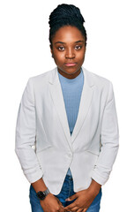 Wall Mural - Young african american woman wearing business clothes looking sleepy and tired, exhausted for fatigue and hangover, lazy eyes in the morning.