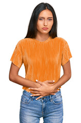 Sticker - Young brunette arab woman wearing casual clothes with hand on stomach because indigestion, painful illness feeling unwell. ache concept.