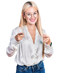 Wall Mural - Beautiful blonde woman wearing elegant shirt and glasses pointing fingers to camera with happy and funny face. good energy and vibes.