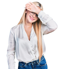 Wall Mural - Beautiful blonde woman wearing elegant shirt and glasses covering eyes with arm smiling cheerful and funny. blind concept.