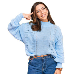 Wall Mural - Young brunette woman wearing casual winter sweater smiling pointing to head with one finger, great idea or thought, good memory