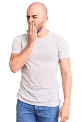 Poster - Young handsome man wearing casual t shirt bored yawning tired covering mouth with hand. restless and sleepiness.