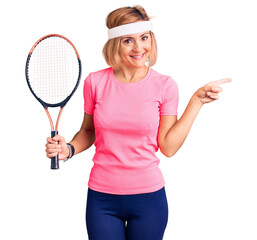 Sticker - Young blonde woman playing tennis holding racket smiling happy pointing with hand and finger to the side