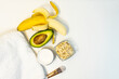 Banana and avocado for a handmade face mask and ingredients on a white table.  Skin care. Homemade natural ingredients for a nourishing face mask, top view. Places to copy. Selective focus.
