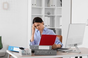 Sticker - Stressed young businesswoman with folders sitting at table in office