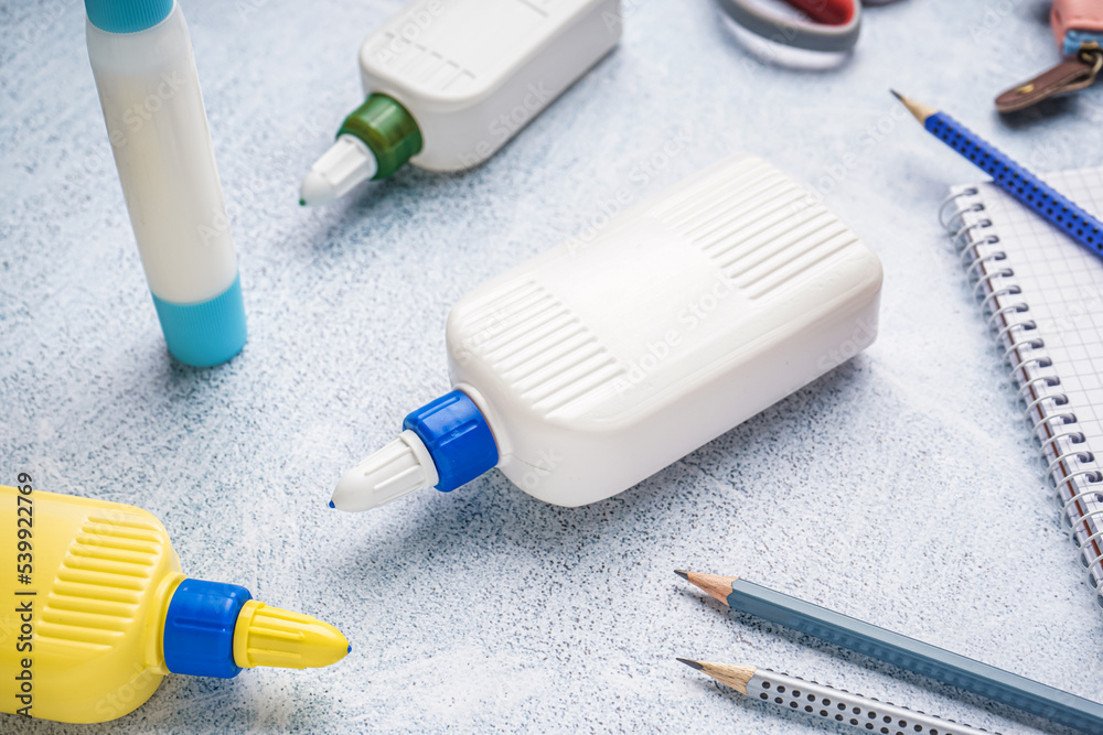 Bottles of glue on grunge background, closeup