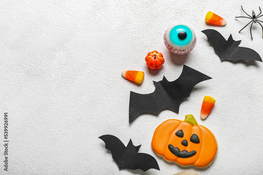 Different Halloween decor with paper bats on light background