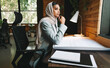 © Jacob Lund - Thoughtful Muslim achitect working in a coworking space