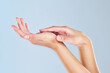 © Deen Jacobs/peopleimages.com - Skincare, beauty and manicure with hands of woman and massage palm for wellness, health and spa against a blue background in studio. Salon, cosmetics and luxury with girl hand for clean dermatology