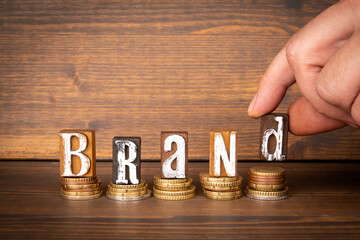 Wall Mural - brand. business development concept. wooden letters and a male hand on a wooden background