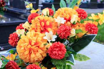 Beautiful bouquet with artificial orange roses and chrysanthemums.