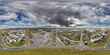 aerial full seamless spherical hdri 360 panorama view above road junction with traffic in small provincial town with private sector and high-rise apartment buildings in equirectangular projection.